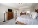 Comfortable bedroom featuring neutral walls and carpet, complemented by wood furniture and cozy bedding at 11592 Saltford Ln, Fishers, IN 46037