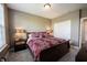 Comfortable bedroom with a plush bed, soft carpet, neutral wall color, and ambient lighting at 11592 Saltford Ln, Fishers, IN 46037