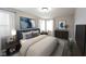 Well-lit bedroom boasts a plush bed, side tables, modern lighting, and tasteful decor, creating a serene atmosphere at 11592 Saltford Ln, Fishers, IN 46037