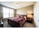 Cozy bedroom with plush carpeting, a queen-size bed, and two bedside tables with lamps at 11592 Saltford Ln, Fishers, IN 46037
