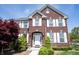 Charming brick home with white trim, a manicured front yard, and tasteful landscaping at 11592 Saltford Ln, Fishers, IN 46037