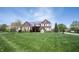 Classic brick home with a well-maintained lawn and mature trees in a suburban setting at 11592 Saltford Ln, Fishers, IN 46037