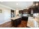 Beautiful kitchen with granite countertops, stainless steel appliances, a kitchen island, and dark wood cabinetry at 11592 Saltford Ln, Fishers, IN 46037