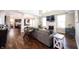 Spacious living room with a fireplace, hardwood floors, and a comfortable sofa at 11592 Saltford Ln, Fishers, IN 46037