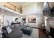 Bright and spacious living area featuring hardwood floors, an open floor plan, and a cozy fireplace at 11592 Saltford Ln, Fishers, IN 46037