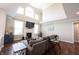 Inviting living room with a fireplace, hardwood floors, and ample natural light at 11592 Saltford Ln, Fishers, IN 46037
