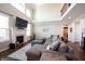 Open-concept living room boasts a fireplace, high ceilings, and ample natural light with stylish furniture at 11592 Saltford Ln, Fishers, IN 46037