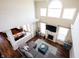Open-concept living room with a fireplace, hardwood floors, and large windows at 11592 Saltford Ln, Fishers, IN 46037