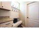 Bright mudroom with white cabinets, granite countertop, and convenient hooks for coats at 11592 Saltford Ln, Fishers, IN 46037