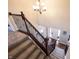 Elegant staircase with decorative iron railings and a view of the front entrance at 11592 Saltford Ln, Fishers, IN 46037