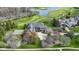 Aerial view of an estate on a golf course, featuring a basketball court and beautiful landscaping at 12010 Landover Ln, Fishers, IN 46037