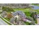 Expansive estate home with a four-car garage, manicured lawn, and mature trees, backing onto a golf course and a pond at 12010 Landover Ln, Fishers, IN 46037