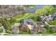 Luxury estate with a meticulously maintained lawn, surrounded by a golf course, a pond, and mature trees at 12010 Landover Ln, Fishers, IN 46037