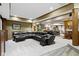 Spacious finished basement with leather sectional, massage chair, and bar area at 12010 Landover Ln, Fishers, IN 46037