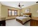 This bedroom features neutral walls, a ceiling fan, and a large window for ample natural light at 12010 Landover Ln, Fishers, IN 46037
