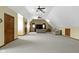 Expansive bonus room featuring neutral walls, plush carpet, and an entertainment area at 12010 Landover Ln, Fishers, IN 46037