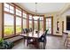 Cozy breakfast nook features bay window and dining set with golf course views at 12010 Landover Ln, Fishers, IN 46037
