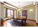 Elegant dining room with hardwood floors, chandelier lighting, and a decorative rug at 12010 Landover Ln, Fishers, IN 46037