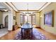 Elegant dining room with hardwood floors, chandelier lighting, and a decorative rug at 12010 Landover Ln, Fishers, IN 46037
