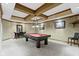 Basement game room with pool table, poker table and seating beneath decorative ceiling at 12010 Landover Ln, Fishers, IN 46037