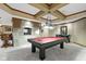 Spacious game room with pool table, game table, and fireplace feature at 12010 Landover Ln, Fishers, IN 46037