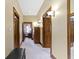 Inviting hallway featuring decorative sconces, wood trim, and neutral tones at 12010 Landover Ln, Fishers, IN 46037