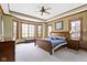 Spacious main bedroom boasts tray ceilings, plush carpet, and large windows at 12010 Landover Ln, Fishers, IN 46037