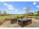 A cozy outdoor patio features wicker furniture with views of the golf course and tranquil lake beyond at 12010 Landover Ln, Fishers, IN 46037