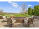 Outdoor patio featuring a cozy fire pit and comfortable seating with scenic backyard views at 12010 Landover Ln, Fishers, IN 46037