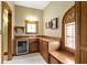 This wet bar includes wooden cabinets, a sink, and a beverage fridge for your convenience at 12010 Landover Ln, Fishers, IN 46037