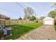 Spacious backyard featuring a new wooden fence, detached garage, and well-maintained lawn at 1209 N Downey Ave, Indianapolis, IN 46219