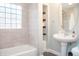 This bathroom features a stylish vanity, unique tile work, and abundant natural light through a window at 1209 N Downey Ave, Indianapolis, IN 46219