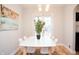 Bright dining area with a modern table, stylish chairs, contemporary lighting, and artistic decor at 1209 N Downey Ave, Indianapolis, IN 46219