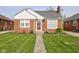 Charming brick home featuring a well-manicured lawn, classic architecture, and inviting front entrance at 1209 N Downey Ave, Indianapolis, IN 46219