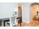 Bright home office featuring a modern desk setup, hardwood floors, and easy access to other living areas at 1209 N Downey Ave, Indianapolis, IN 46219