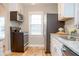 Modern kitchen with stainless steel appliances, granite countertops, and sleek black and white cabinetry at 1209 N Downey Ave, Indianapolis, IN 46219