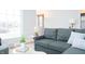 Comfortable living room with a plush sofa, stylish decor, and bright natural light, perfect for relaxing at 1209 N Downey Ave, Indianapolis, IN 46219