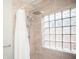 Modern bathroom with a rainfall showerhead, refreshing glass-block window, and soothing tile design at 1209 N Downey Ave, Indianapolis, IN 46219