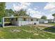 A home's backyard featuring a covered patio area and grassy lawn, perfect for outdoor enjoyment at 1212 N 10Th St, Elwood, IN 46036
