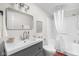 Bathroom with modern fixtures, including a vanity sink, toilet, and shower-tub combo at 1212 N 10Th St, Elwood, IN 46036