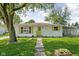 Charming single-story home with neat landscaping, vibrant shutters, and a welcoming walkway at 1212 N 10Th St, Elwood, IN 46036