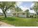 Charming single-story home with neat landscaping and covered outdoor seating area at 1212 N 10Th St, Elwood, IN 46036
