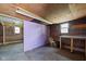 A garage with a partial finished wall and wood frame, window and concrete flooring at 1212 N 10Th St, Elwood, IN 46036