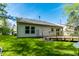 Well-maintained backyard with a wooden deck, grassy area, and the home's exterior featuring vinyl siding at 12210 Doncaster Ct, Fishers, IN 46037