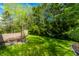 Expansive backyard with a wooden deck, manicured lawn, and mature trees offering ample shade and privacy at 12210 Doncaster Ct, Fishers, IN 46037