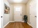 Inviting entryway with hardwood floors, white trim, and a stylish front door with glass panels at 12210 Doncaster Ct, Fishers, IN 46037