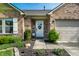 Welcoming front entrance with a white door, decorative wreath, and neatly arranged landscaping at 12210 Doncaster Ct, Fishers, IN 46037