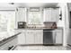 Charming kitchen with white cabinetry, granite countertops, and stainless steel appliances at 12210 Doncaster Ct, Fishers, IN 46037