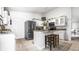 Bright kitchen with stainless appliances, an island with seating, and a refrigerator at 12210 Doncaster Ct, Fishers, IN 46037
