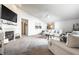Spacious living room with vaulted ceilings, a fireplace, and neutral carpeting at 12210 Doncaster Ct, Fishers, IN 46037